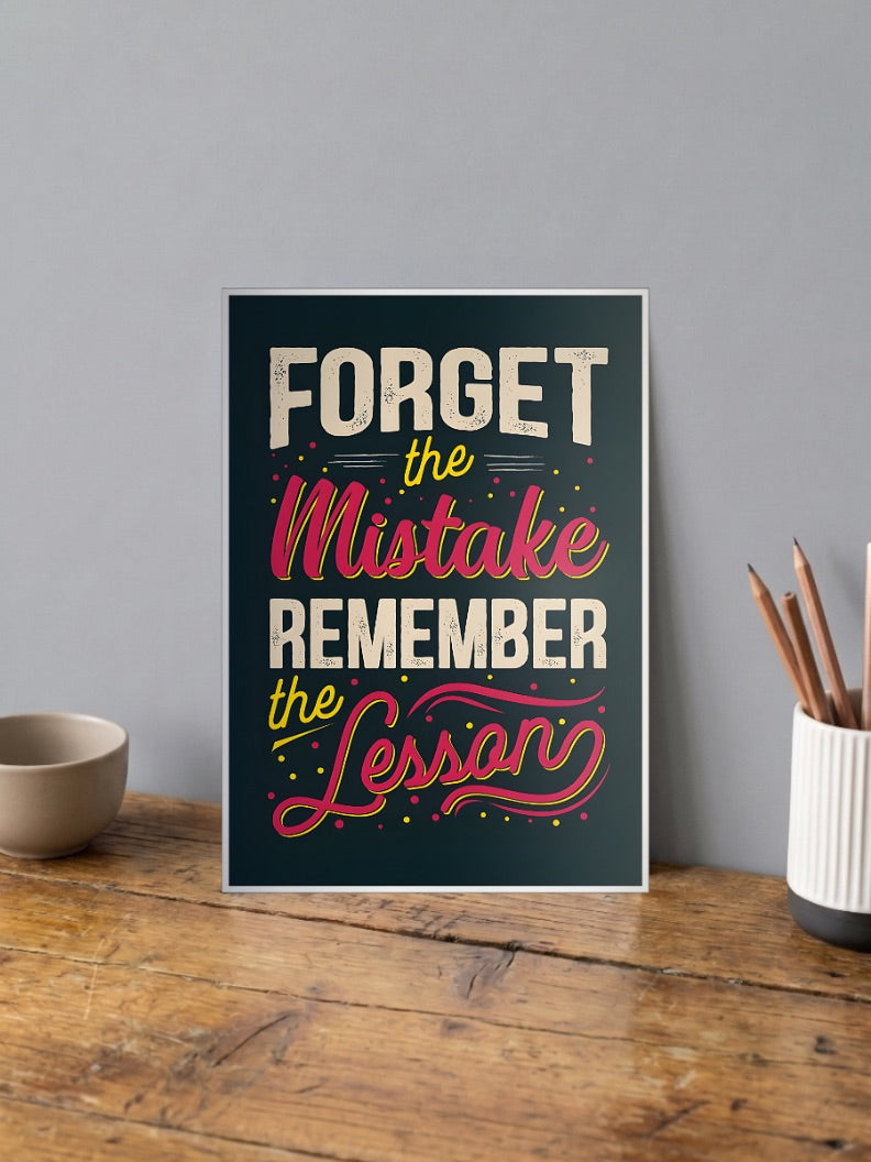Forget Mistake Remember Lesson Quotes Poster shown in A4 size on a wooden desk