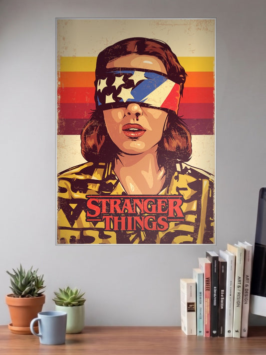 Eleven Blindfolded Retro Poster Netflix Poster shown in A3 size on a wall above a study desk