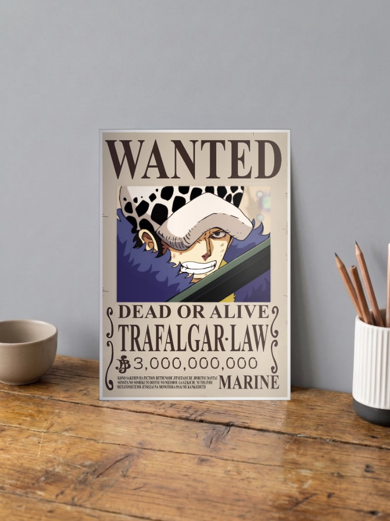 Trafalgar Law Wanted Anime Poster shown in A4 size on a wooden desk